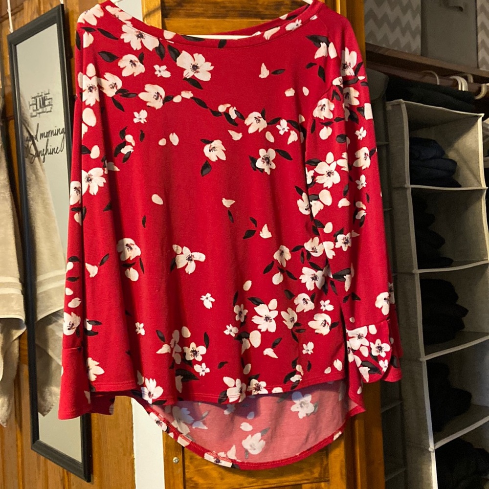 Red floral top with flare sleeves.